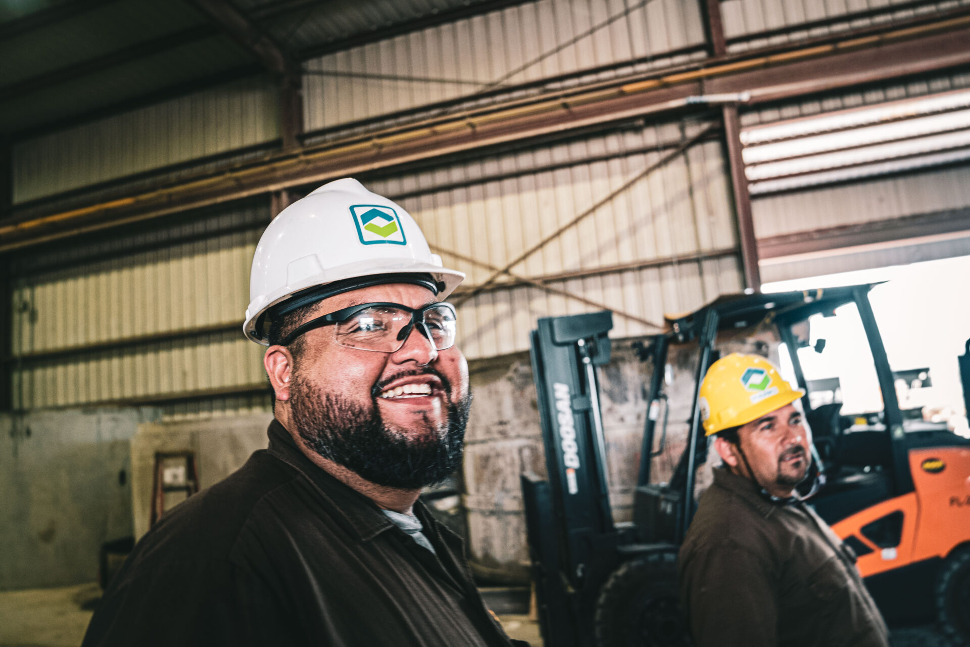 employee smiling at a plant