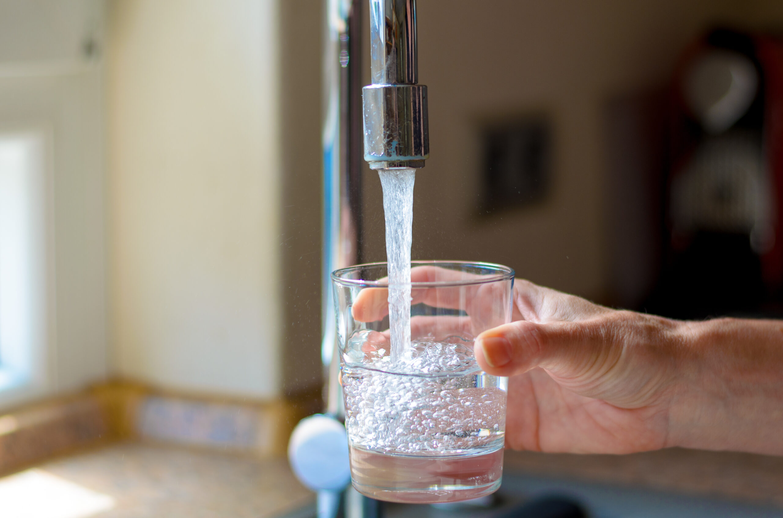 filling glass of water at the sink