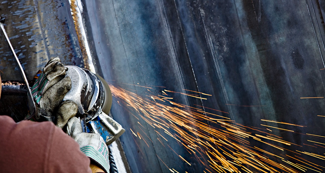 grinder on metal with sparks flying