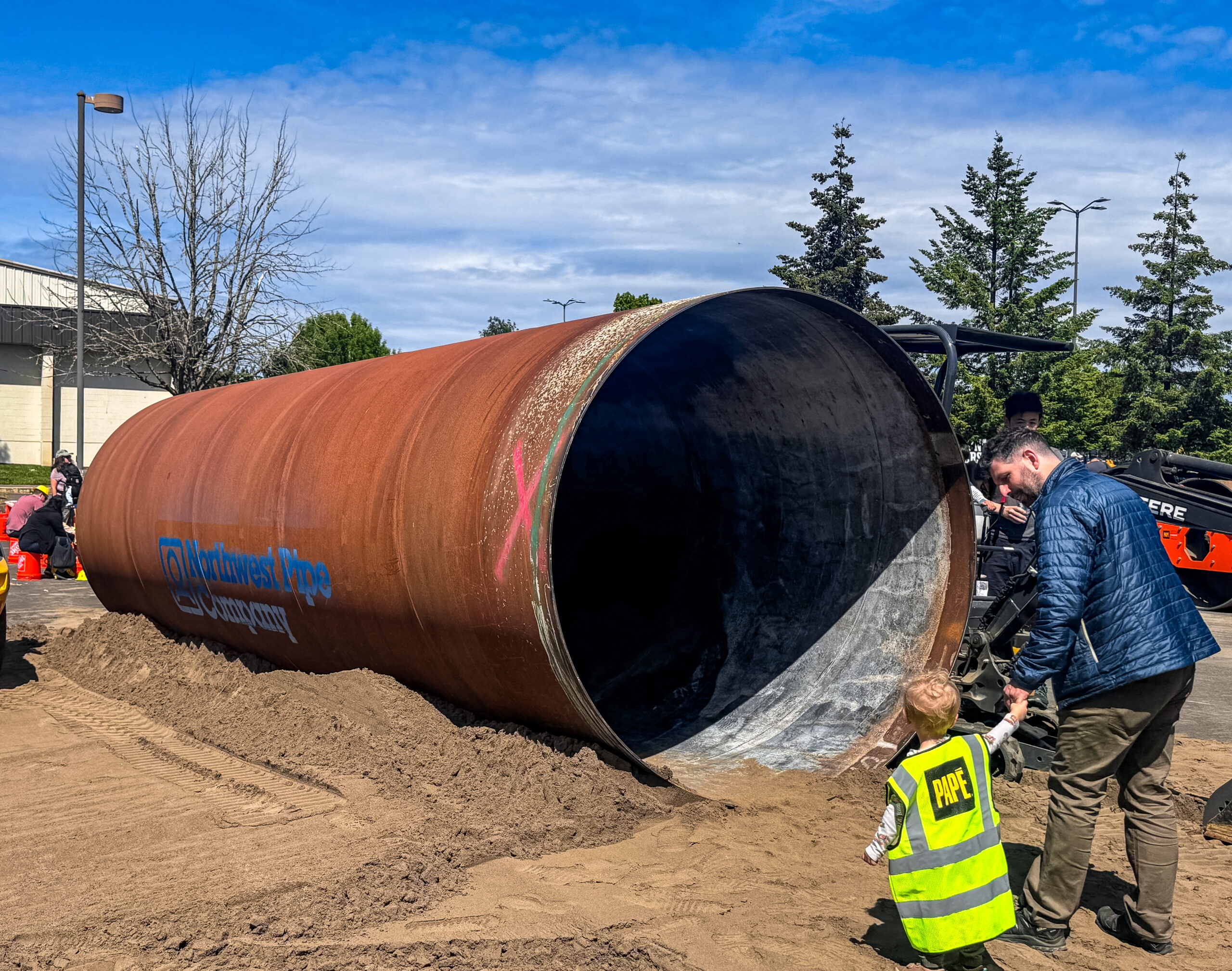 people standing in front of a pipe